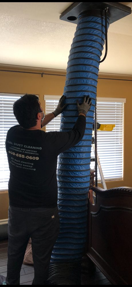 Cal Duct Cleaning technician in branded uniform working at a Bay Area home