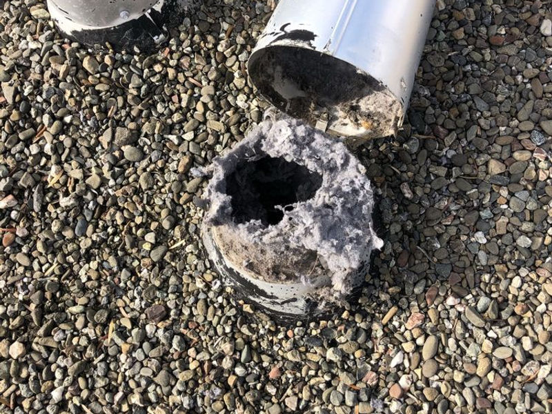 Lint buildup inside a dryer vent duct creating a fire hazard
