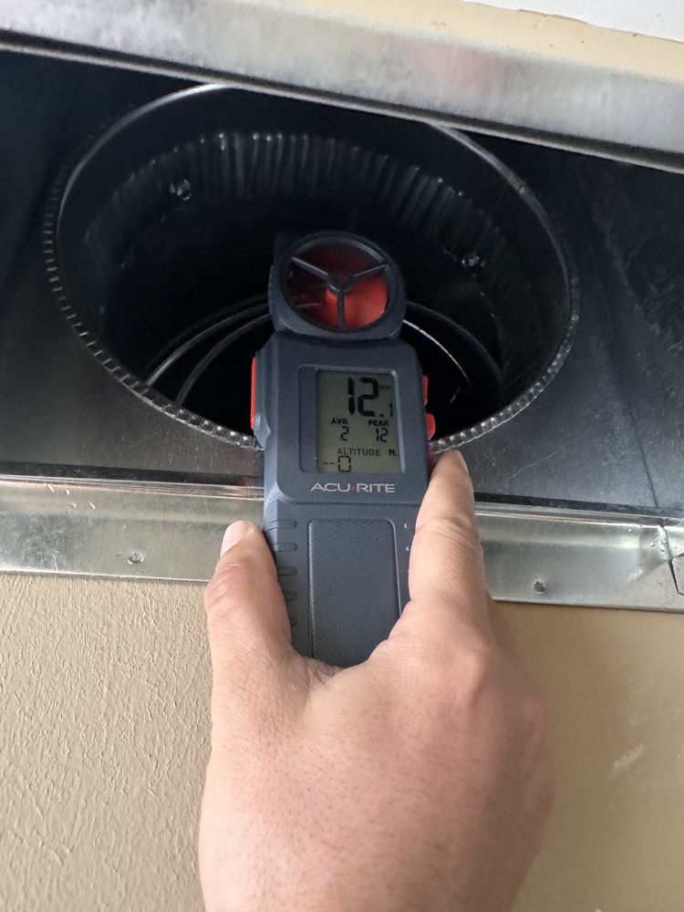 Technician verifying register airflow after duct cleaning