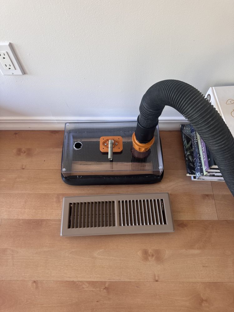 HEPA-filtered collection unit connected at a floor register