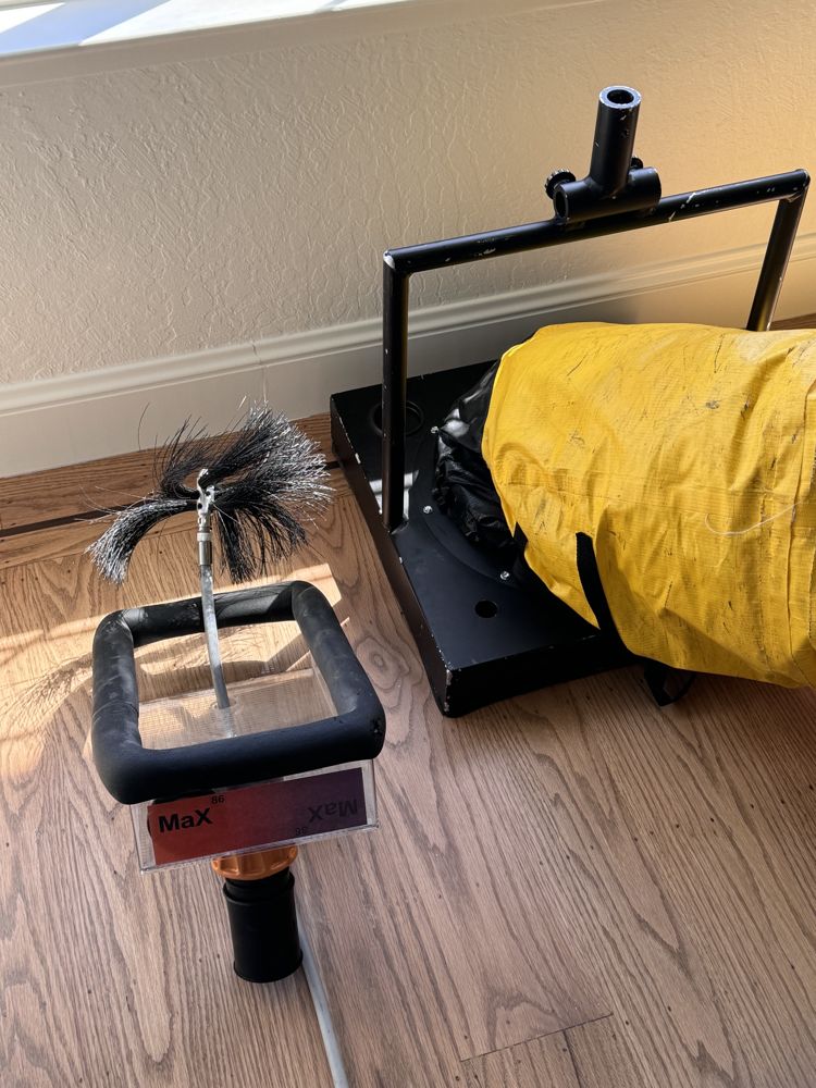 Rotary brush and portable HEPA vacuum staged for air duct cleaning