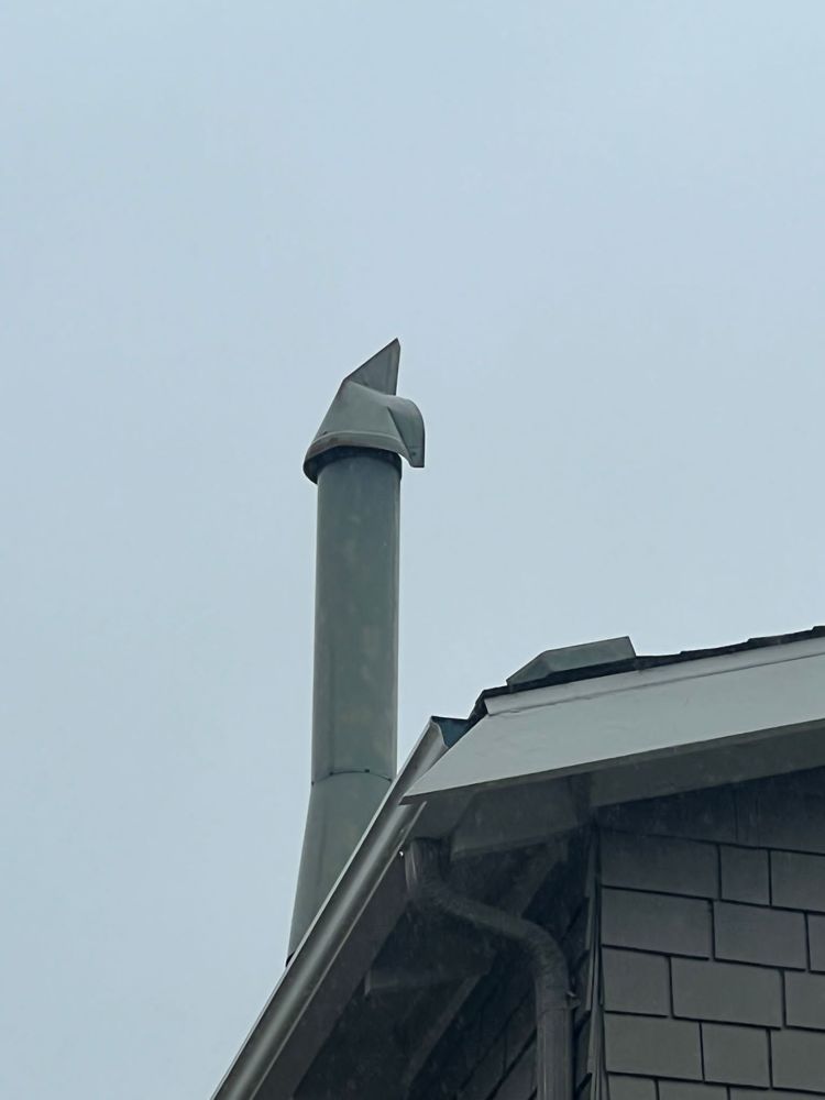 Exterior flue pipe inspected during chimney service