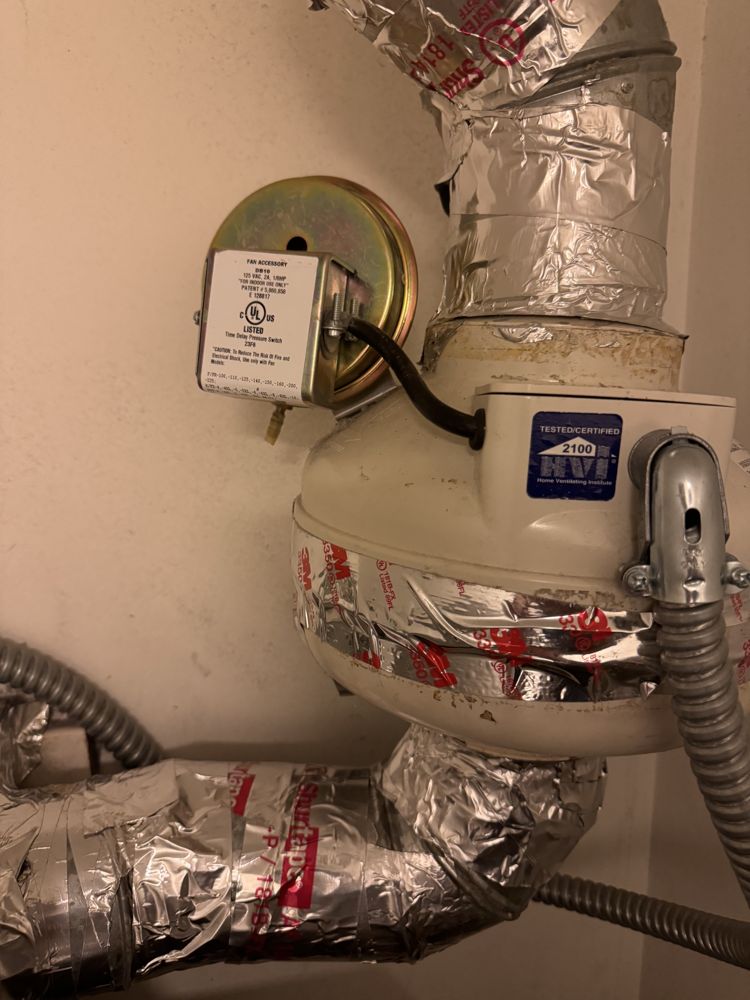 Booster fan and insulated ducting serviced in an attic