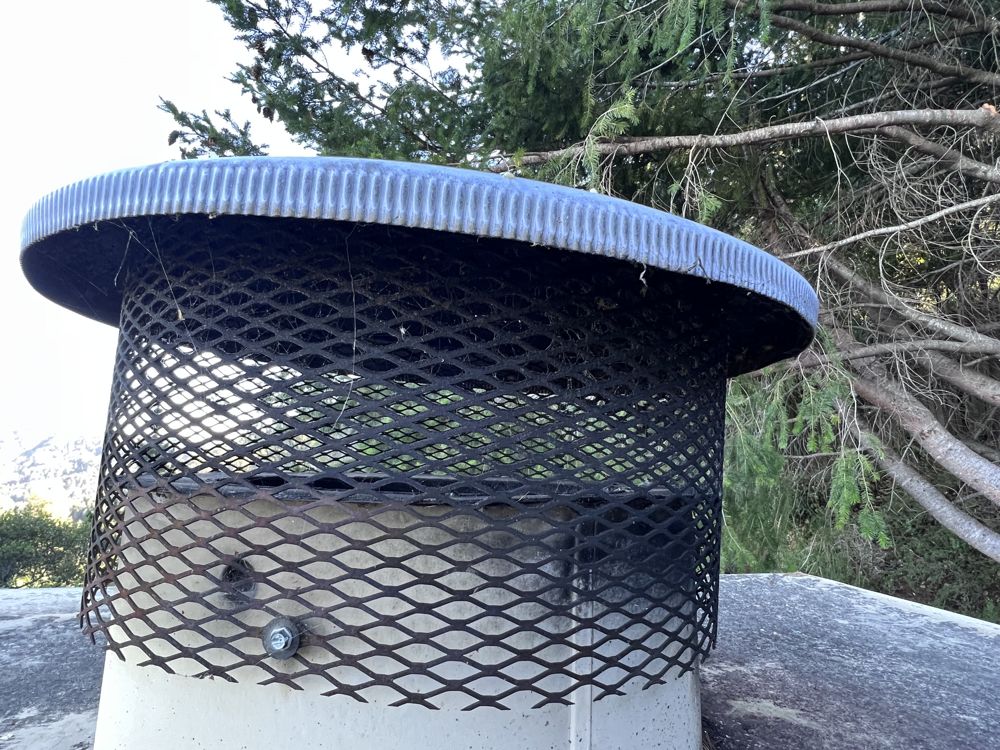 Chimney cap with mesh spark screen installed