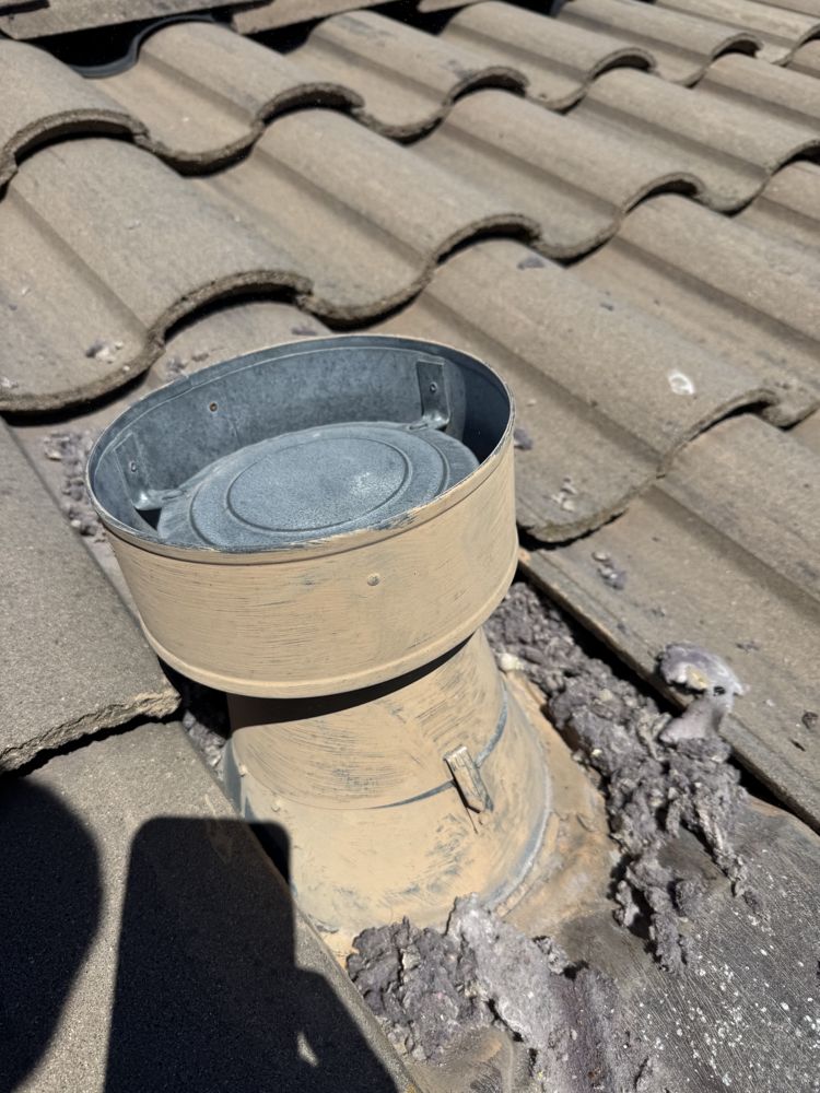 Roof dryer vent termination caked with lint before cleaning