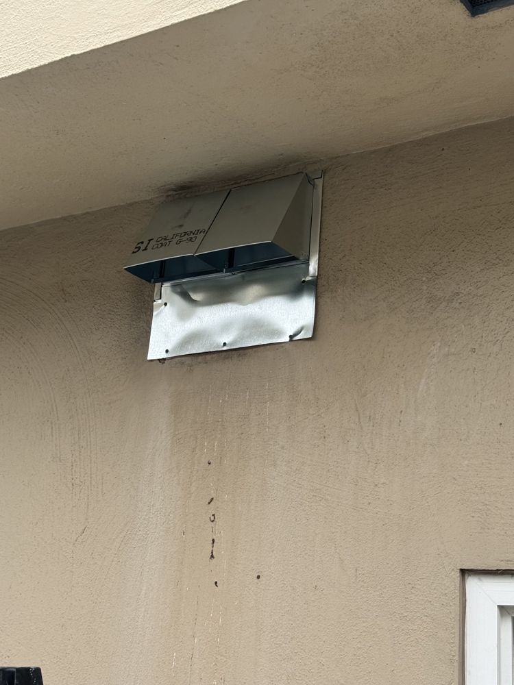New exterior dryer vent hood installed on stucco after service