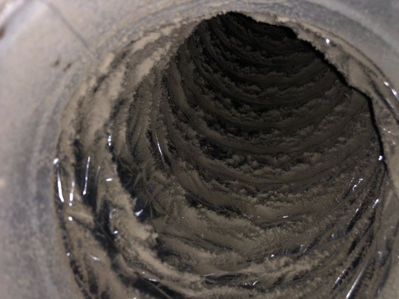 Air duct interior before cleaning - packed with dust and debris