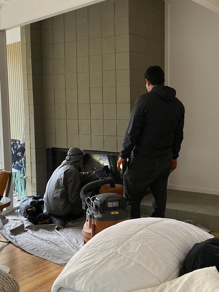 Chimney cleaning in progress by Cal Duct Cleaning